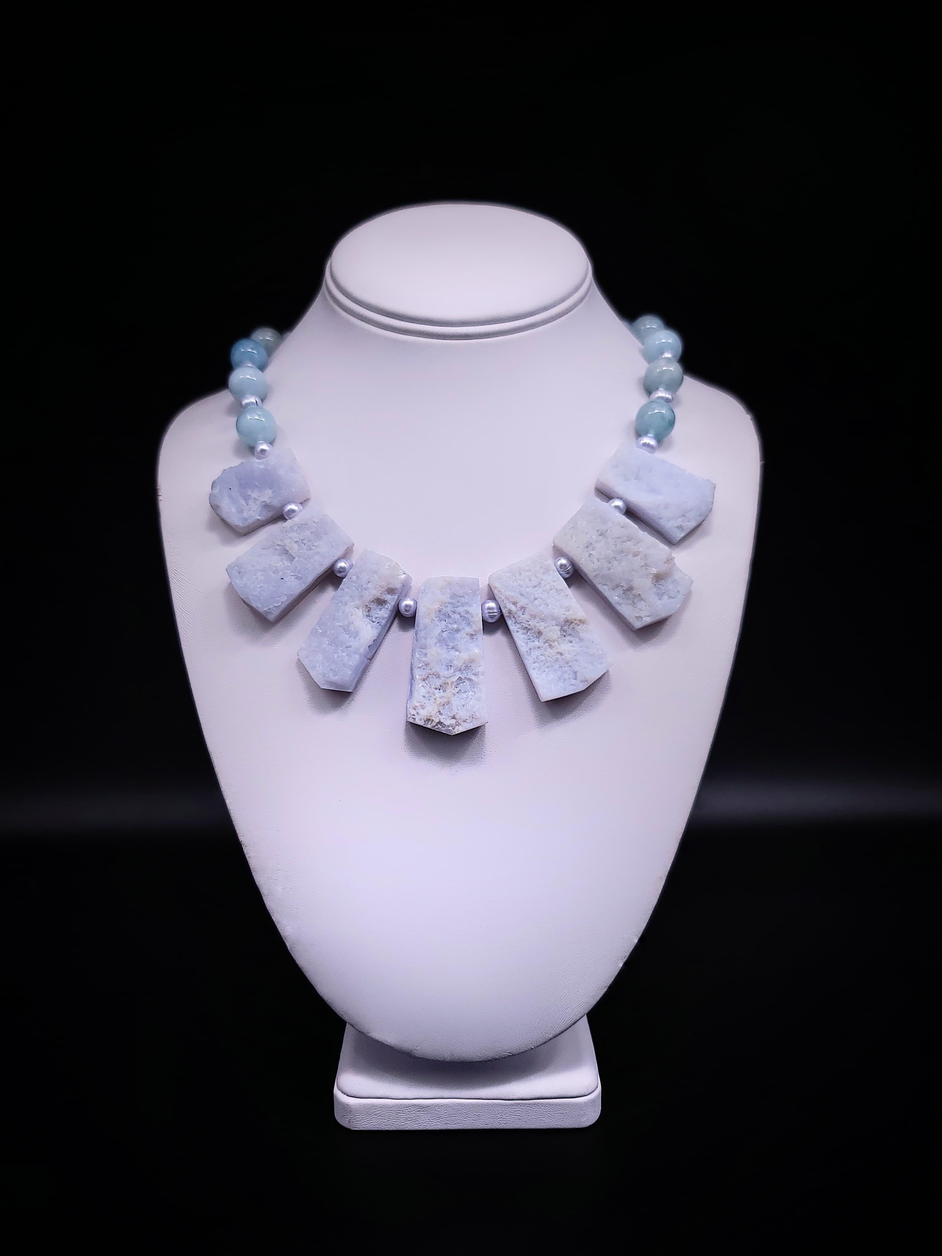 Unparalleled Elegance: Aquamarine and Pearl Symphony

Step into a world of timeless elegance with this exceptional necklace, a true masterpiece that blends multiple shades of blue Aquamarine with the soft allure of gray pearls. Whether you're drawn