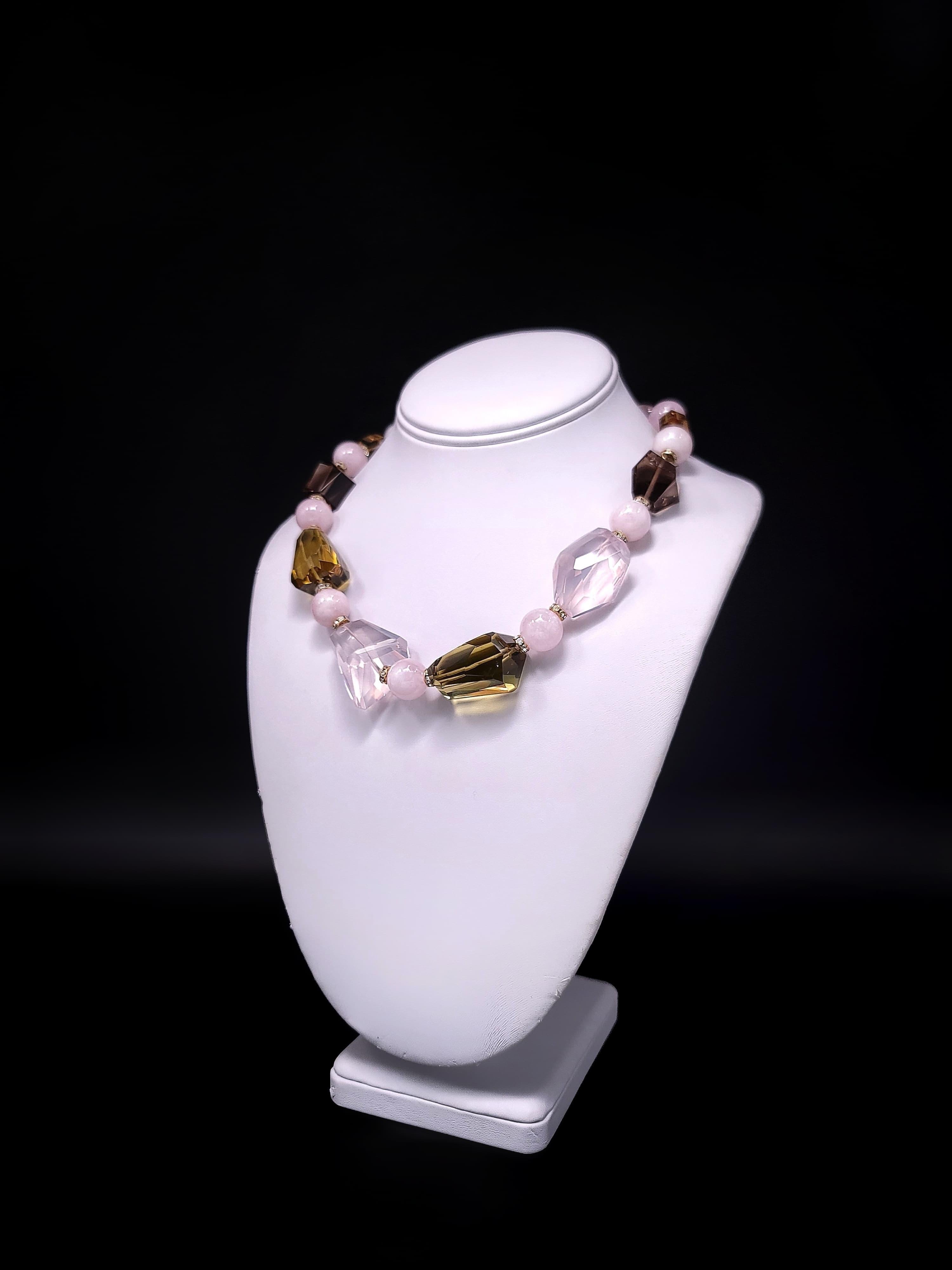 Indulge in the allure of this truly unique creation, a breathtaking symphony of rosy hues and exquisite craftsmanship. Adorned with the understated elegance of large, well-colored transparent Smokey Quartz and the soft, feminine charm of Rose Quartz