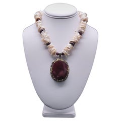A.Jeschel Gorgeous Ruby pendant suspended from a Keshi Pearl necklace.