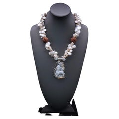 A.Jeschel Pearl necklace with a statement jade pendant.