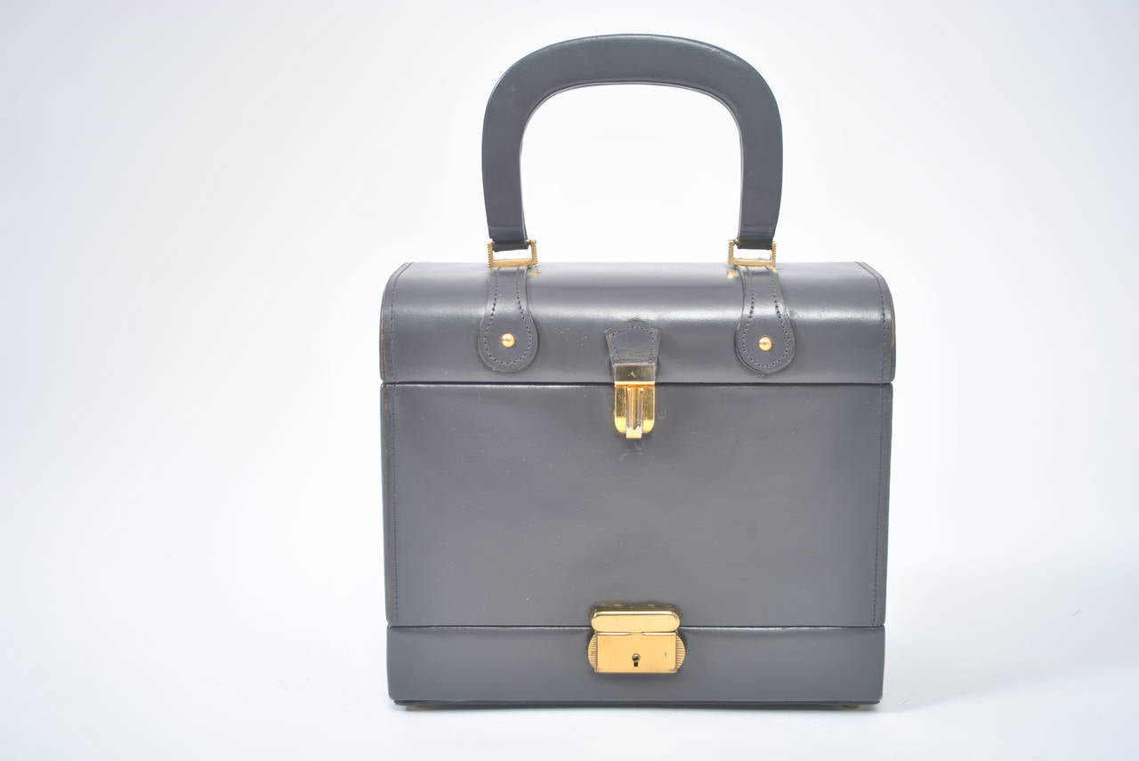 I am always drawn to the box bags that were popular in the 1960s and have had several interesting shapes from this manufacturer. This trunk-like example features a flat bottom compartment that today can accommodate a cell phone, cosmetics, etc. The