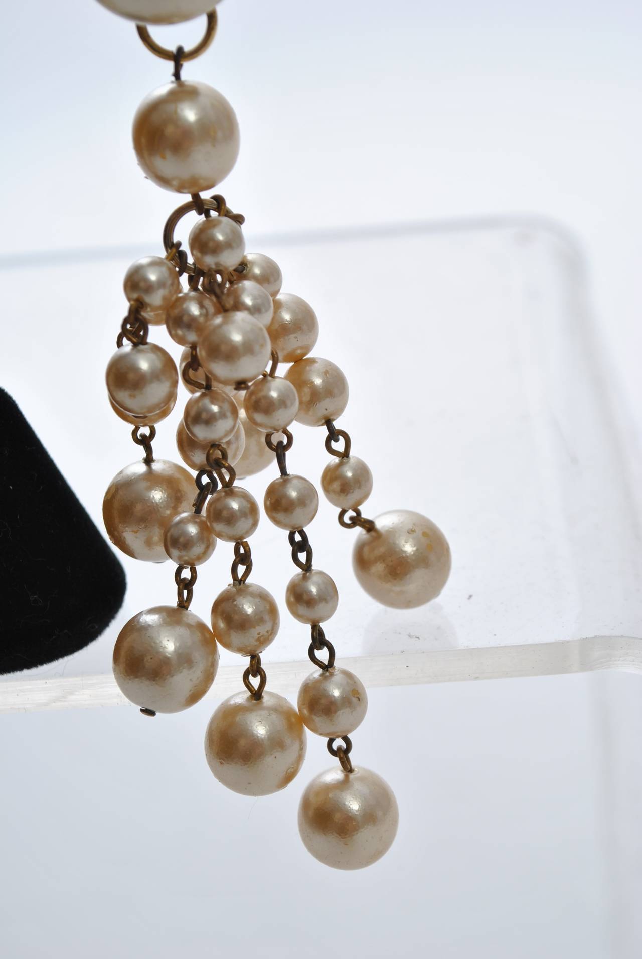 Pearl chandelier earrings suspended from a mabe pearl earpiece.