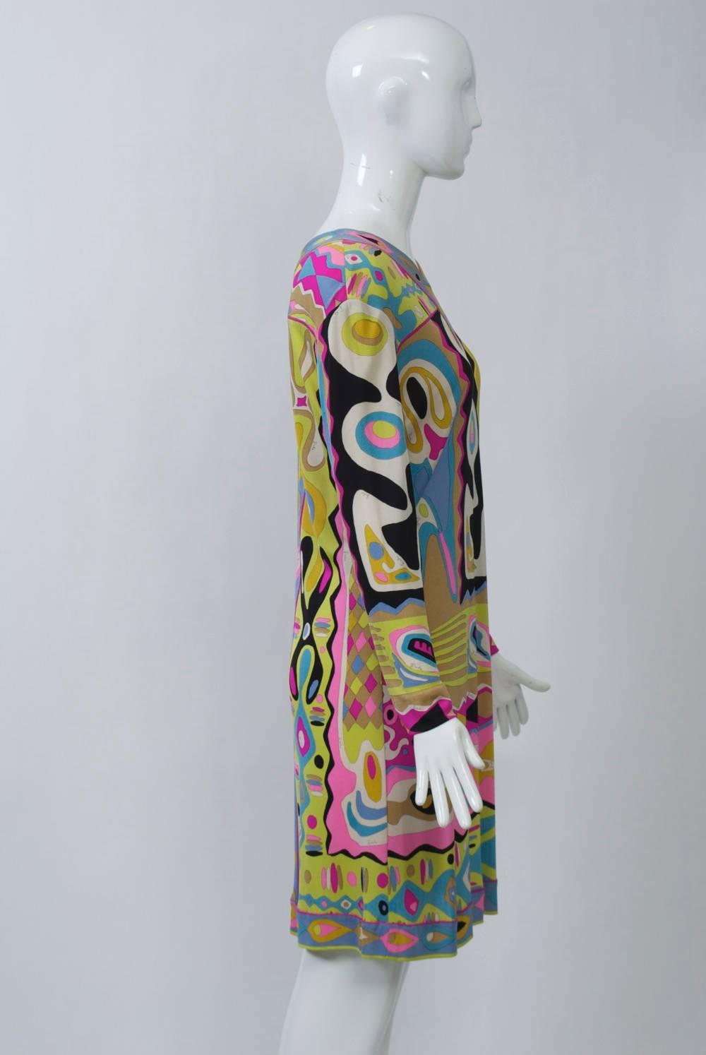 Iconic vintage Pucci dress of silk knit jersey in vivid colors features a bordered V neck and hem, and long sleeves. Marked size 14, probably equivalent to a contemporary size 8-10. Excellent condition. 