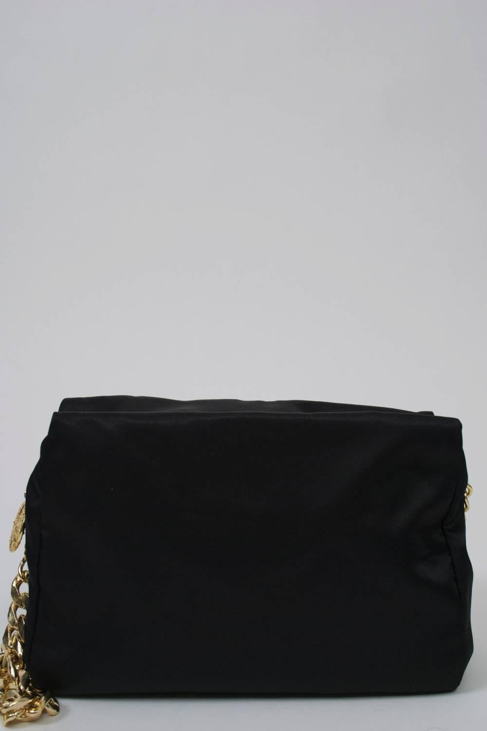Moschino Couture soft shoulder bag in black fabric embroidered with logo, cow, and 