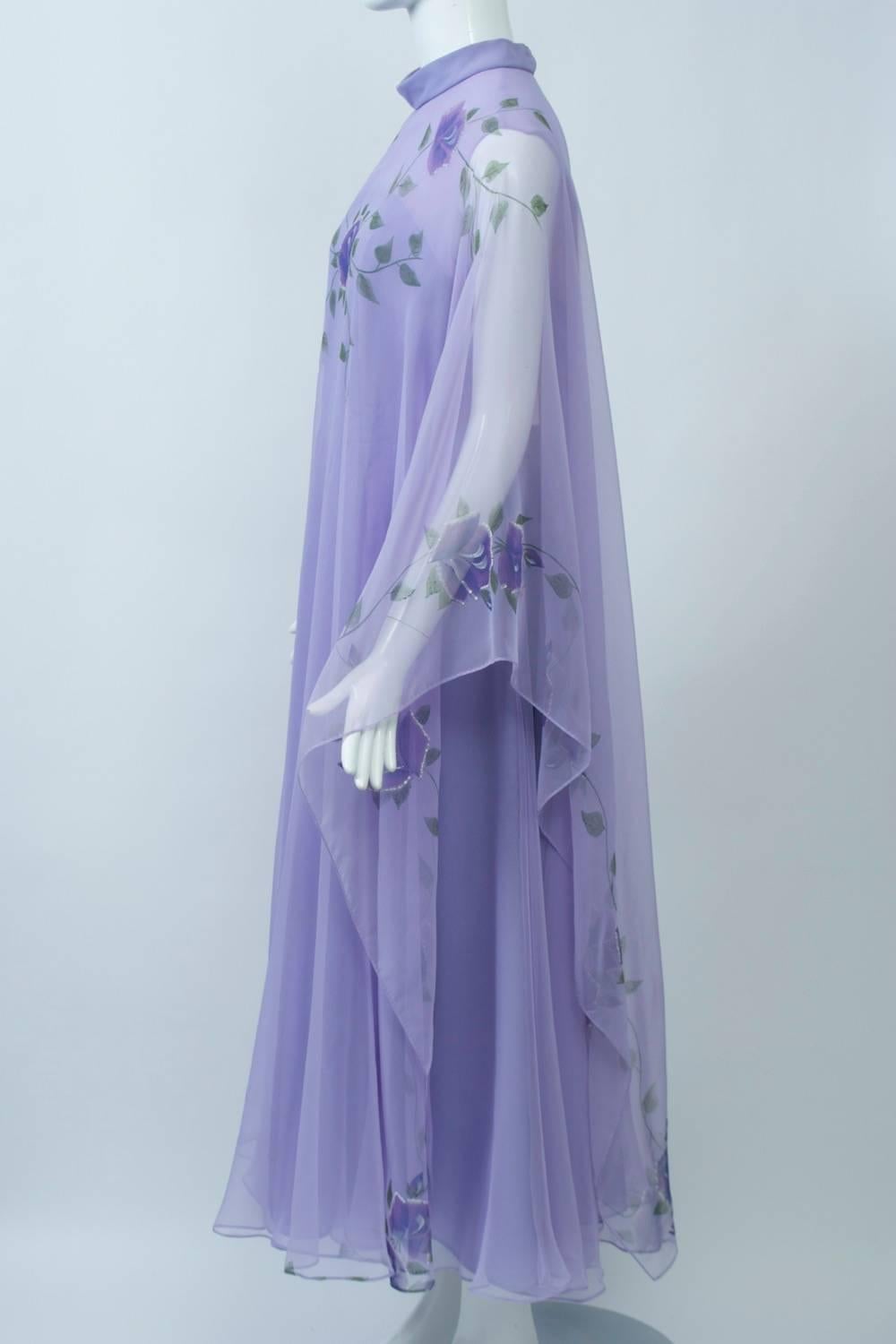 Flowing lavender gown with handpainted floral detail on the outer, turtleneck caftan layer, which is made of sheer synthetic chiffon. Underneath is a fitted, strapless sheath under a matching sheer layer featuring a gored skirt. Back zipper. M-L.