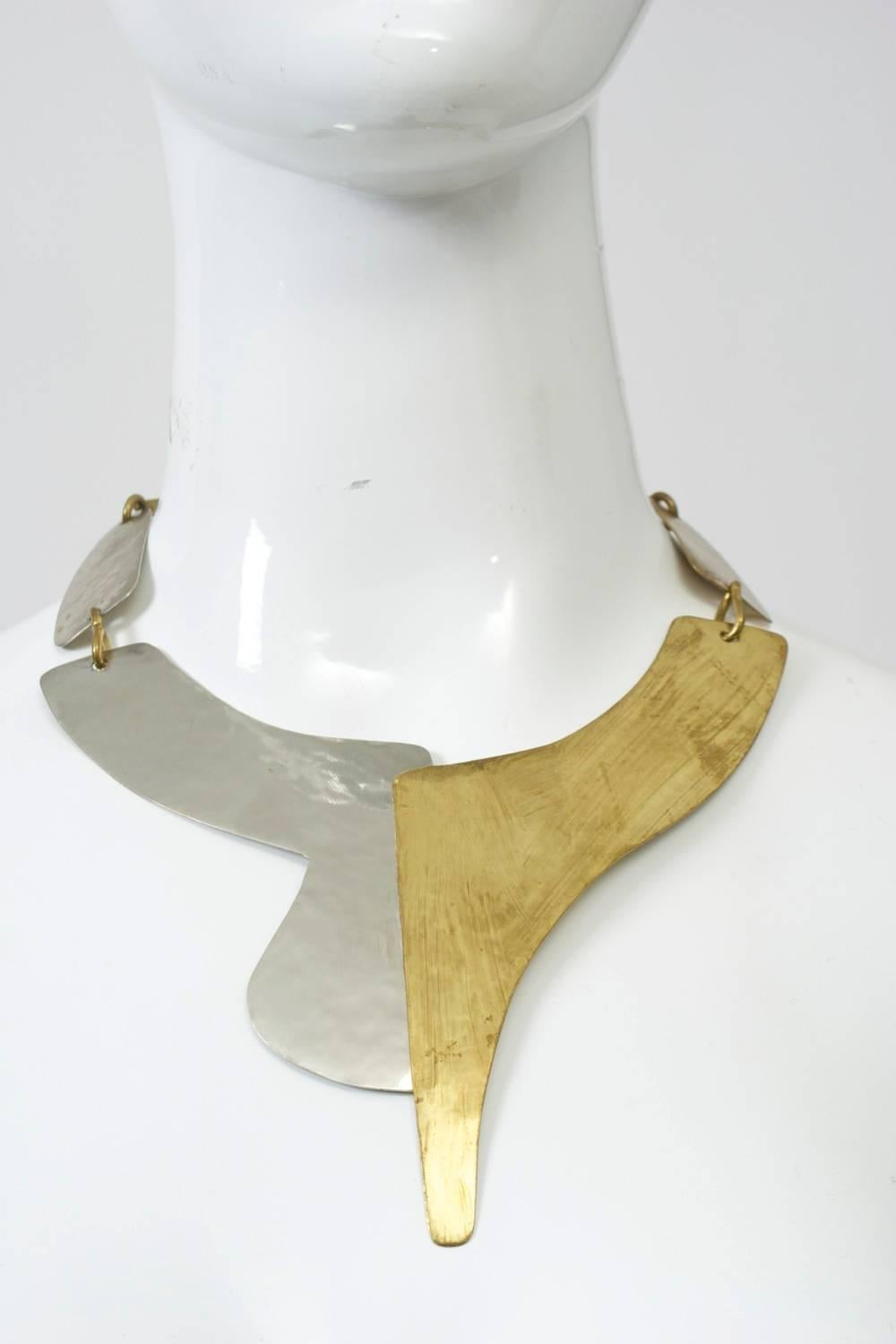Modernist neck piece in mixed metal, composed of two overlapping, curved and asymmetrical components in front. Artist made with hand forged links and hook in back.