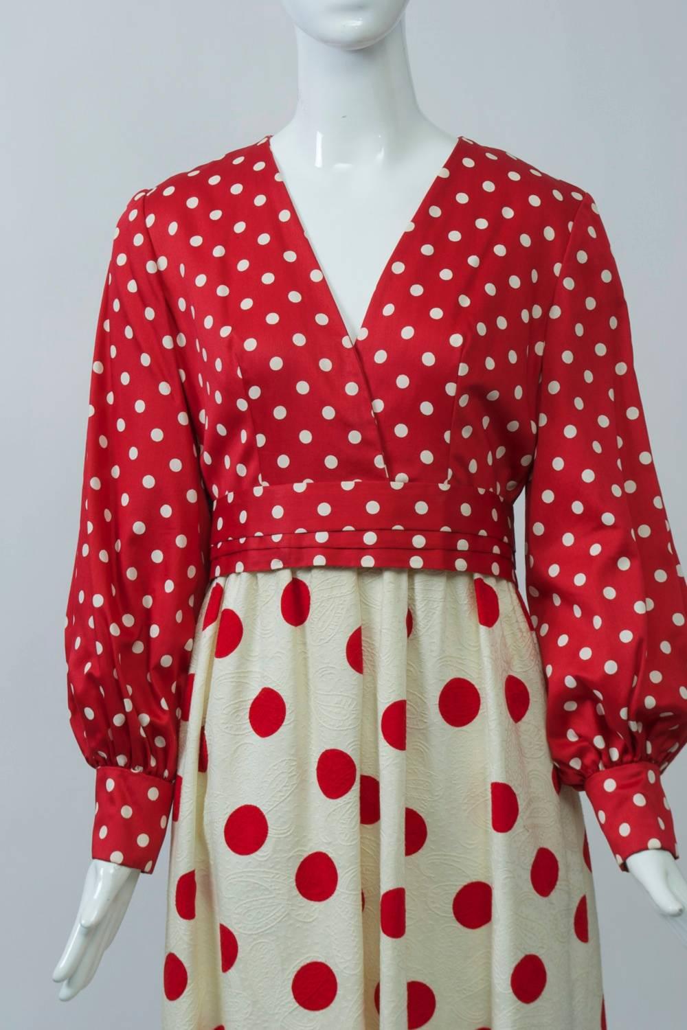 Red and white reverse polka dot maxi dress in polished cotton features a v neck, balloon sleeves and a long skirt. The high-waisted bodice has a red ground with small white polka dots and offers a striking contrast to the skirt, which has an