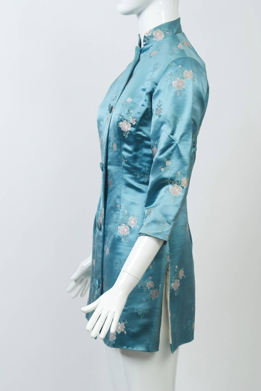 One of the best combinations we've seen for one of these vintage Hong Kong pieces from the 1960s. The brocade tunic jacket, in a beautiful shade of medium blue, has small flowers in pink, which complements the blush pink satin pants. A mandarin