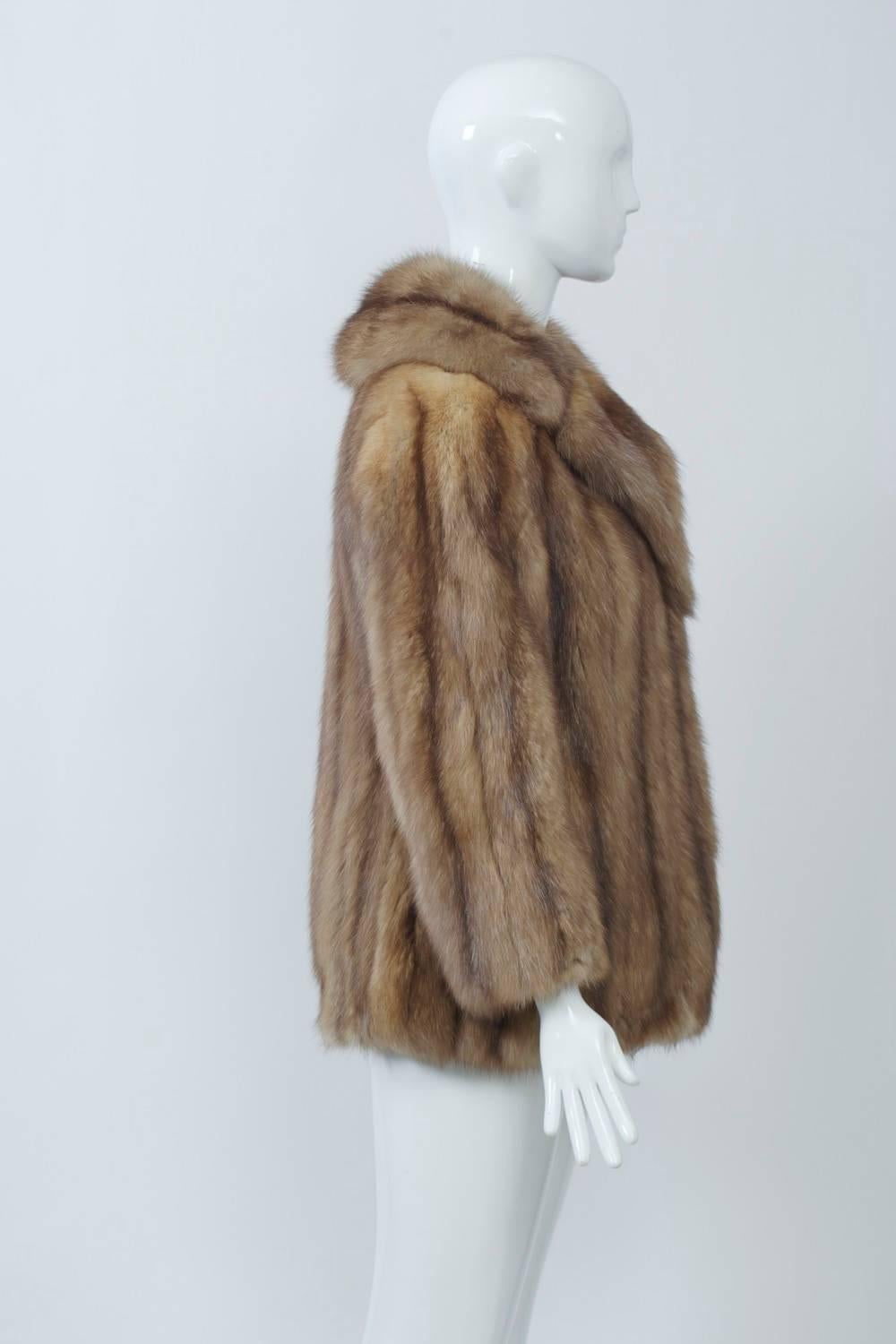Sable jacket of high-quality skins marked by silver tips and a rich medium color from the fur department at Bergdorf Goodman. Trim profile in blazer style with notched collar and slight shaping at waist. Fur-hook closure at front edge. Small size. A