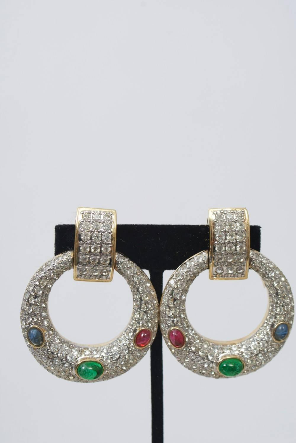 Rhinestone-studded gold metal hoop earrings punctuated by three oval cabochons - green in center, red on one side and blue on the other. By Vogue Bijoux. Great for holiday.