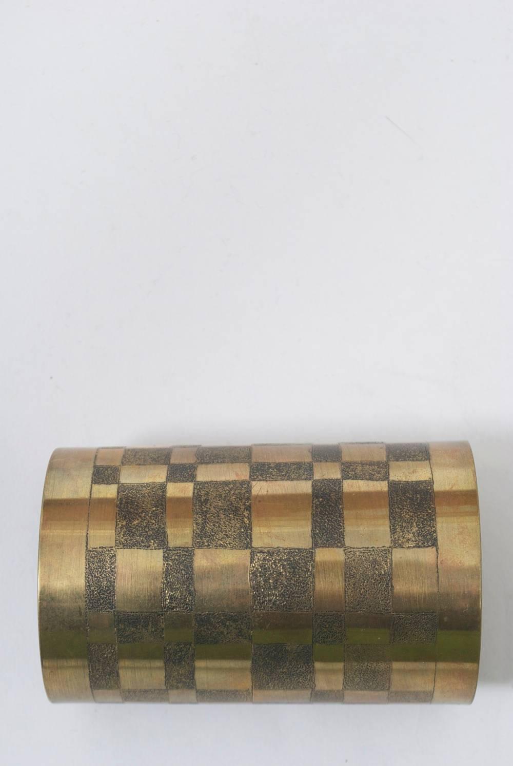 Wide brass cuff featuring a geometric pattern of darkened and textured squares and rectangles. Unsigned, artist piece. Dramatic.