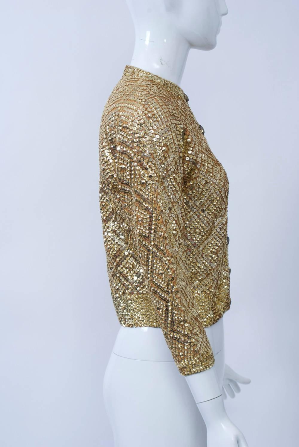 1960s knit cardigan covered allover with gold sequins set in a diamond pattern and finished with matte gold log-shaped buttons. Three-quarter sleeves. Made by high-end Italian knitwear designer Laura Aponte. Approximate size S.