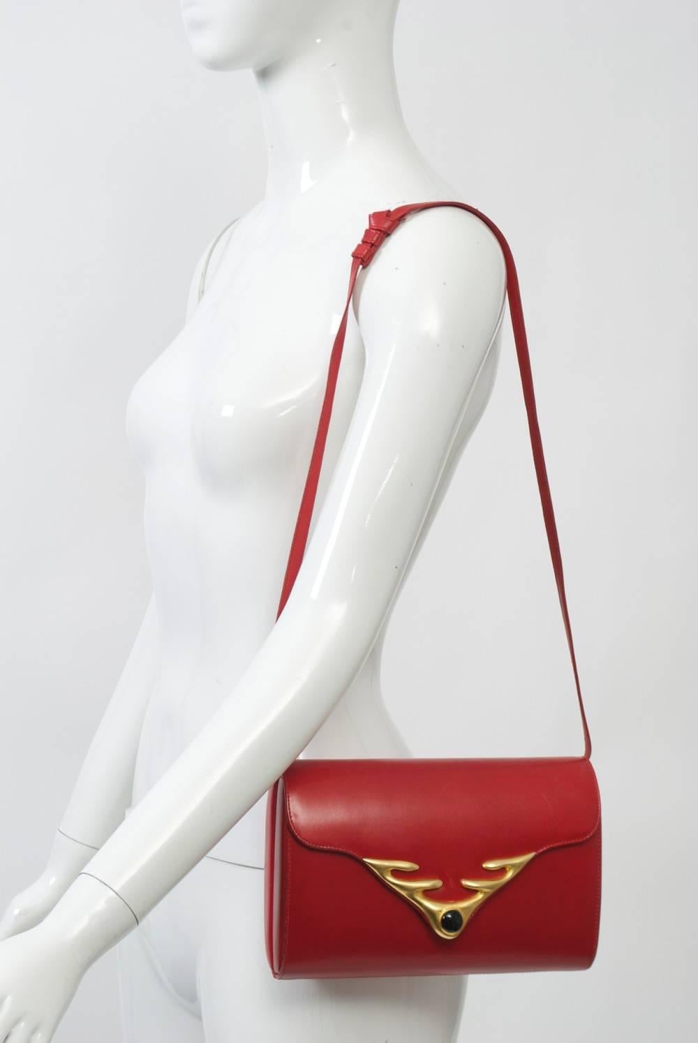 Robert Lee Morris has been a fixture on the modern jewelry scene for over four decades. He also produces accessories, and in this handbag, the dynamism that characterizes his jewelry is evident. Crafted of a smooth red leather, the structured oval