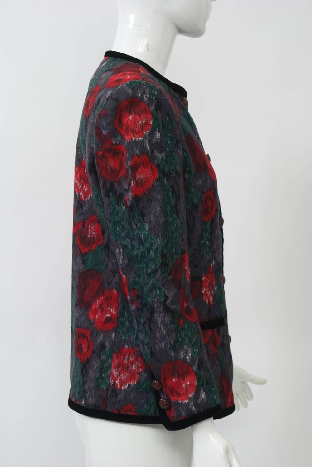 Sheer wool jacket in dark watercolor floral print with velvet edging around jewel neckline, hem, wrists, and along front and pockets. Single breasted with beautiful red rhinestone buttons, which also complement the wrists.