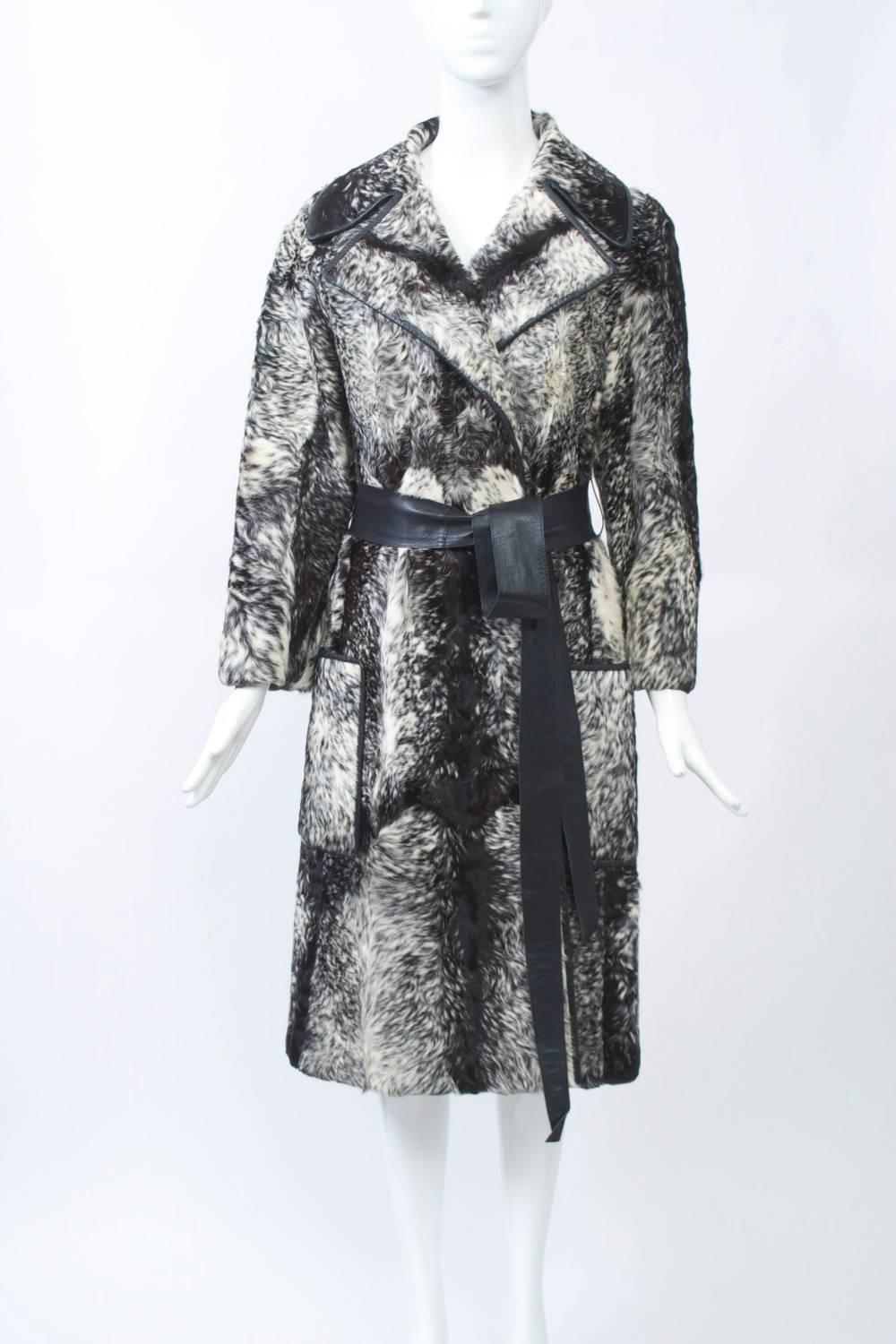 Striking, unusual flat fur, possibly goat, with black and white mottled markings. Wrap style with notch collar, black leather tie belt and large patch pockets. Deep back vent. Black lining. Approximate size 8.