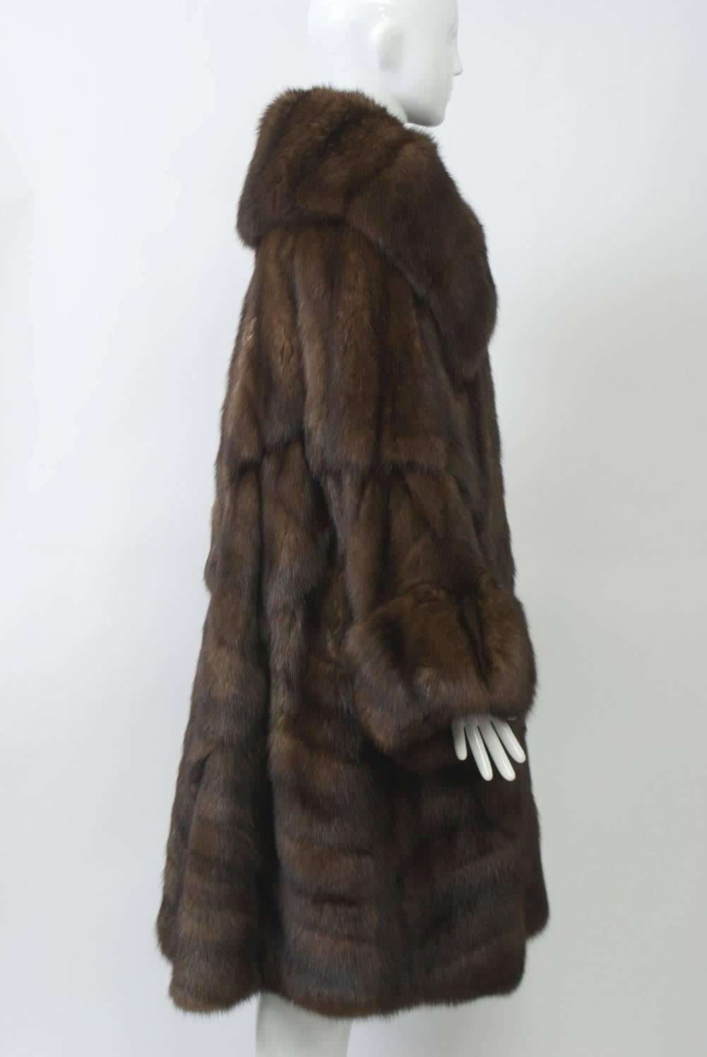 Fabulous and lush sable coat by Fendi featuring a very deep spread collar and wide sleeves with turned-back cuffs. Diagonally oriented skins allow for a wide sweep and an abundance of sable. Two large buttons fasten in front. Lined in cocoa silk