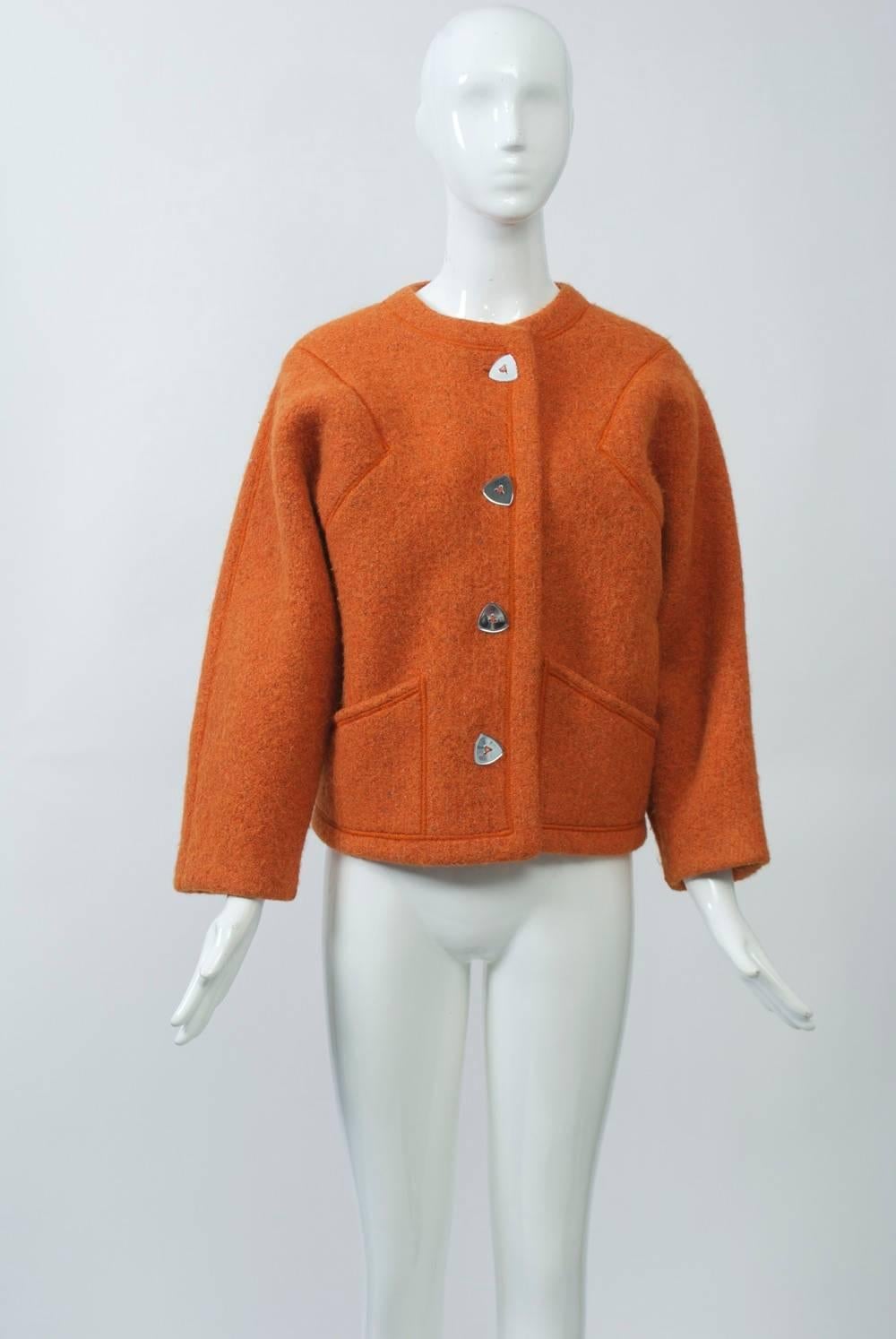 Short jacket in pumpkin boiled wool by Missoni featuring dolman sleeves, welted-seam detailing throughout, and triangular mirrored buttons. Unlined. A great piece. Size S.