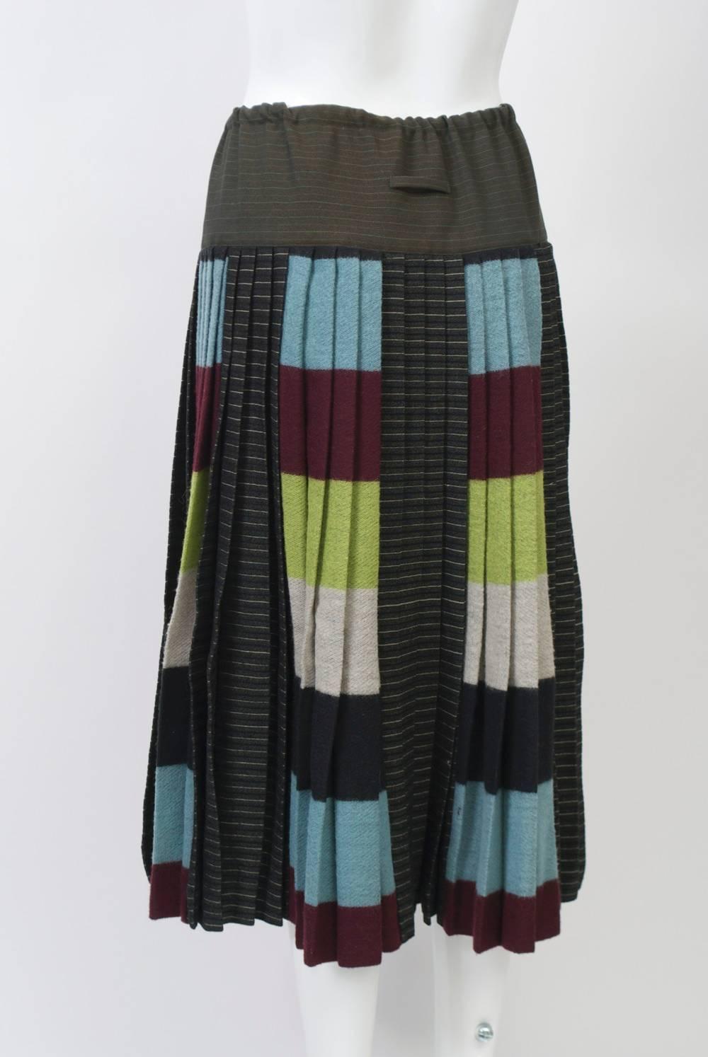 Jean Paul Gaultier knife-pleated skirt in blocks of varied colors, patterns and fabrics (wool, nylon, cotton), a play on combinations for which the designer is well known. The pleats fall from a wide hip band in khaki green with a drawstring waist;