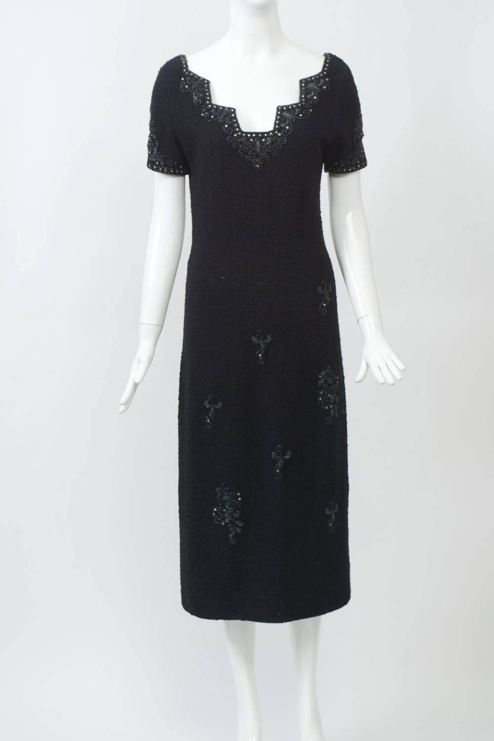 An example of the wonderful knits produced in Hong Kong during the 1950s-'60s, many with unusual features. This dress, slim fitting and body hugging, has an unusual neckline with rectangular cut-ins bordered with rhinestone and beaded embellishment,