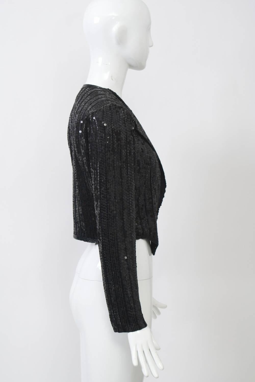 Styled like a men's tuxedo tails coat, this jacket by designer Neil Bieff and artist Arturo Herrera is composed of vertical stripes of black sequins and bugle beads with border trim of the latter. Narrow cut. Beading on a sheer ground. Approximate
