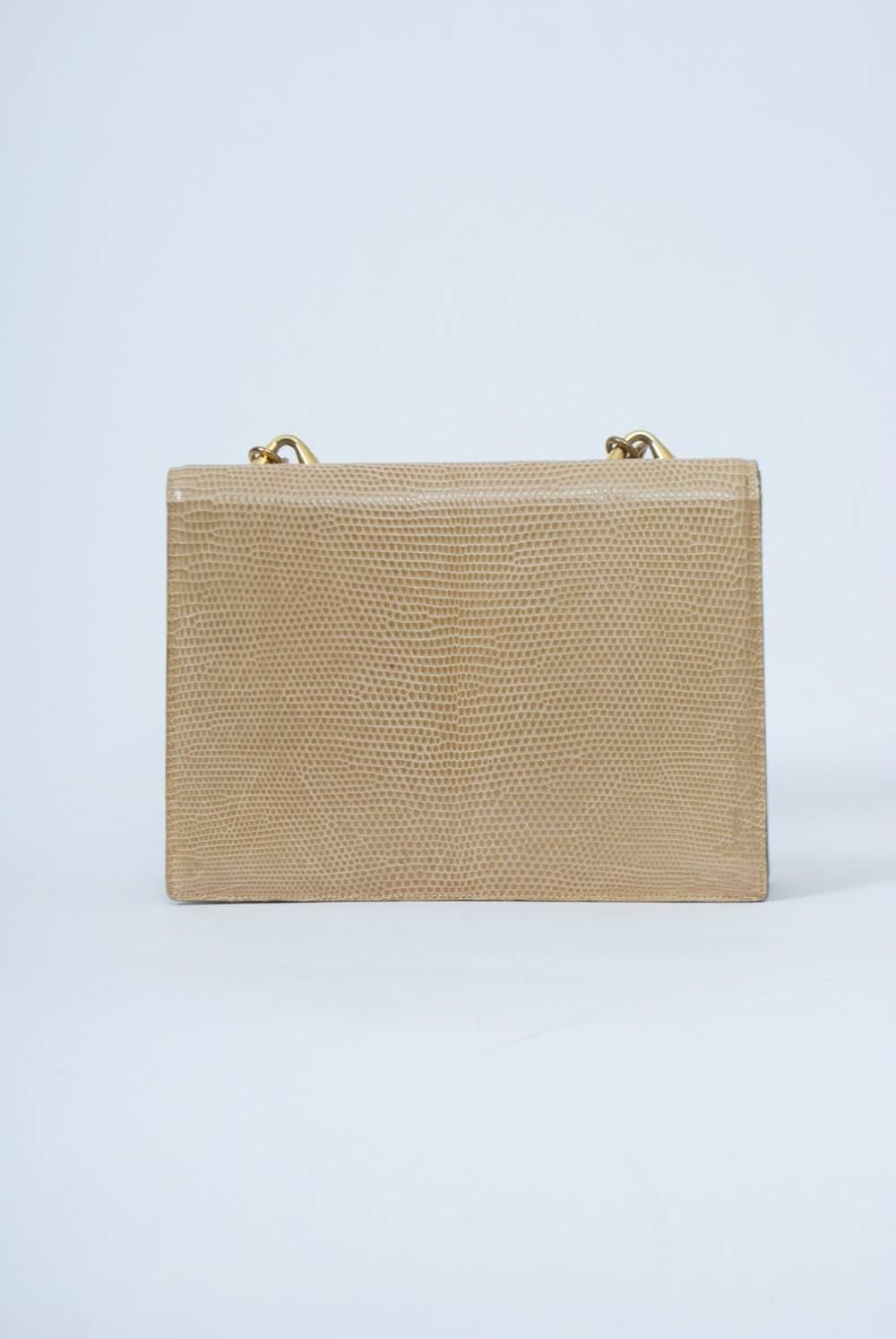 Beige lizard 1960s shoulder bag by Finesse features a heavy gold chain and  structured body with envelope flap and gold ring clasp. Accordion three-section interior with side compartments and separate change purse. Appears little used, with original