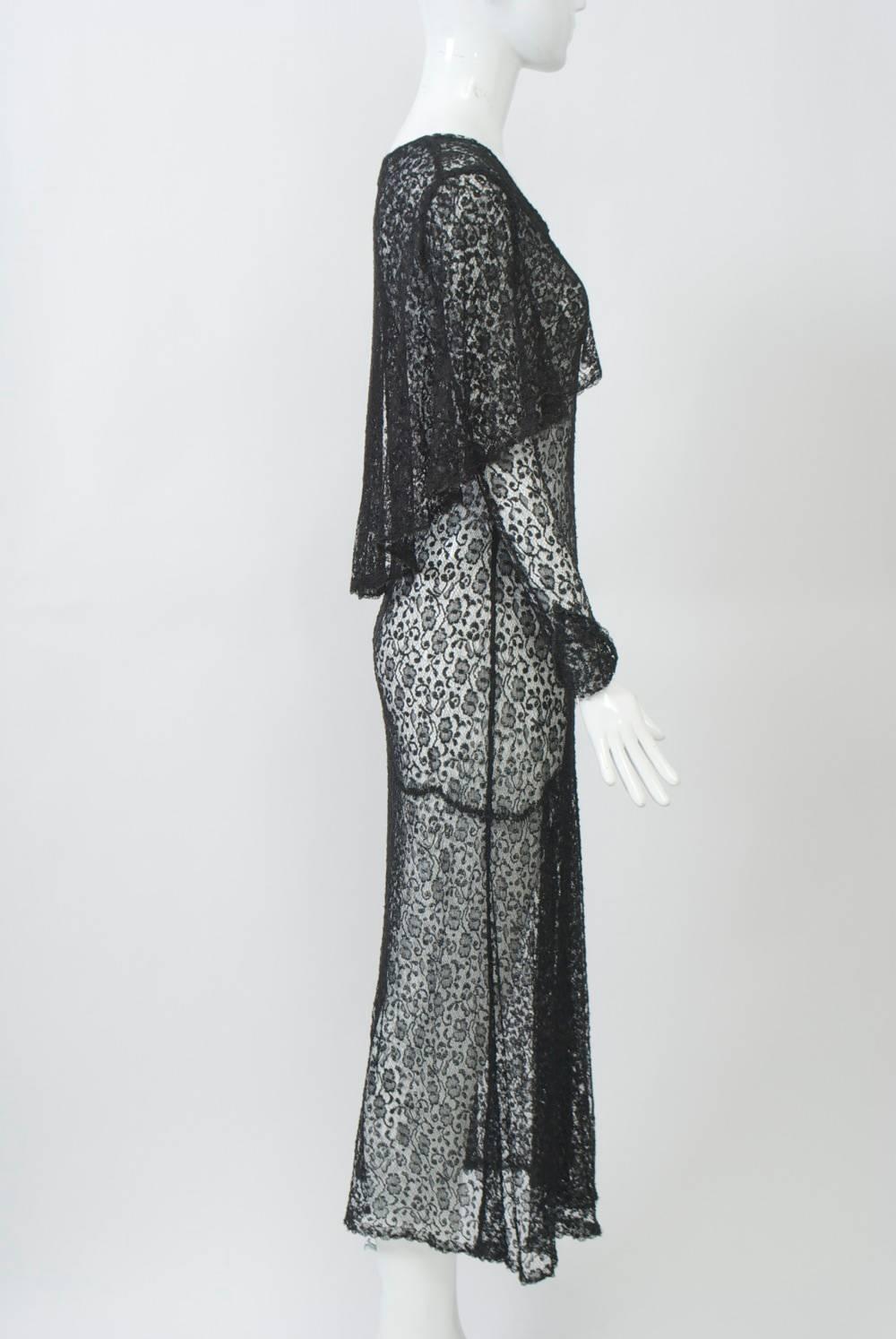 Sheer black lace dress from the 1930s with a fitted bodice through the hips and bias-cut skirt with scalloped seam going from low to high, where it is accented with a gathered pleat. Other features include a sailor-type curved collar that follows