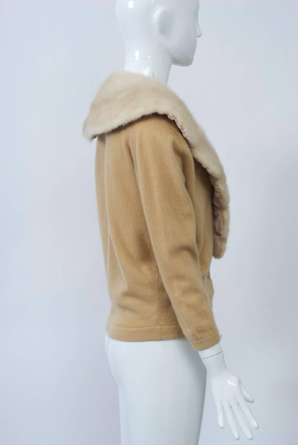 Pringle cashmere cardigan in a deep shade of camel featuring a pale beige mink collar with a scalloped edge. Tapes with snaps sewn onto both the collar and sweater allow the collar to be removed for cleaning of the cardigan. Approximate size M.