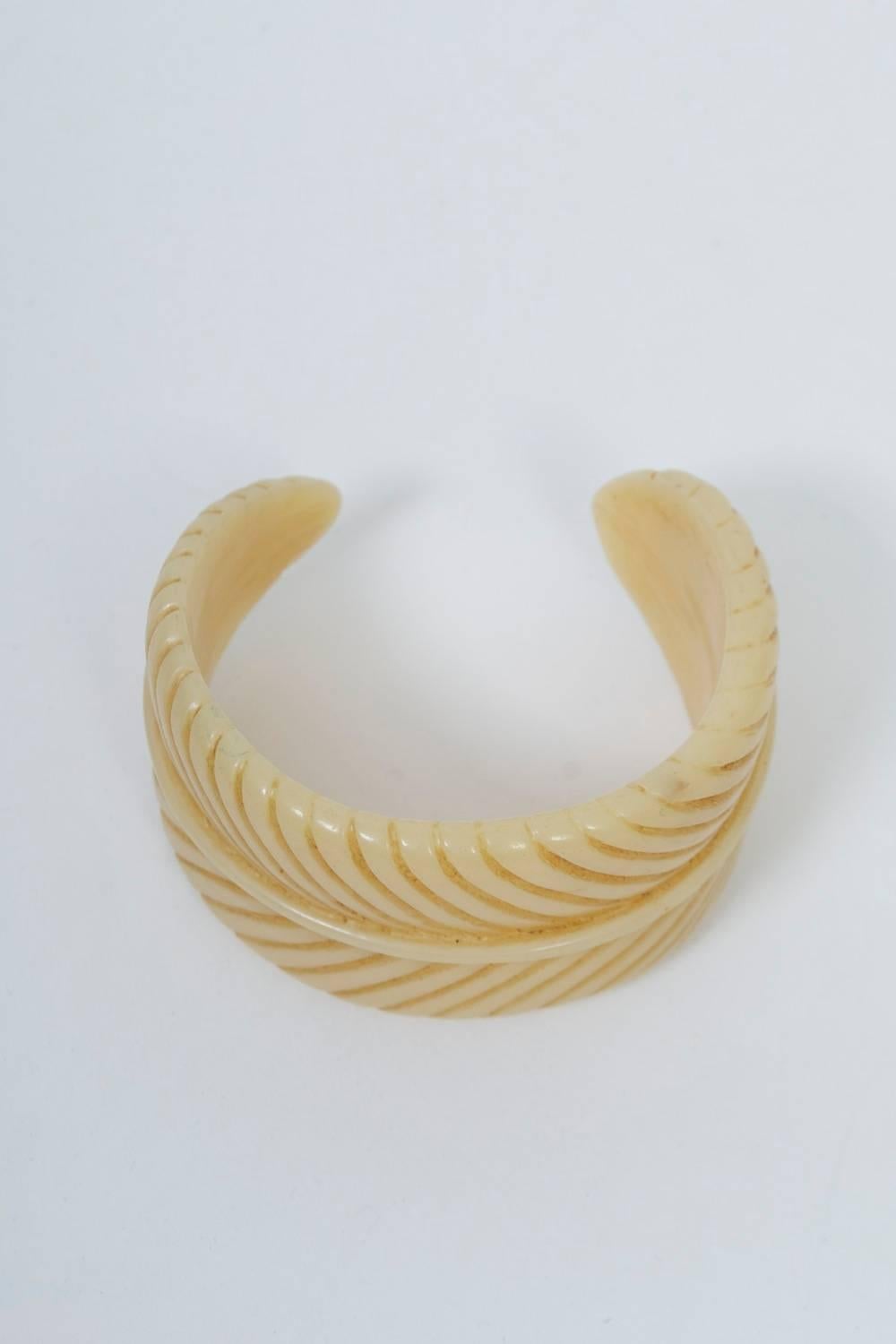 Vintage ivory Bakelite cuff carved as a leaf, a rib runnng down the center with diagonal channels on each side. 1.75