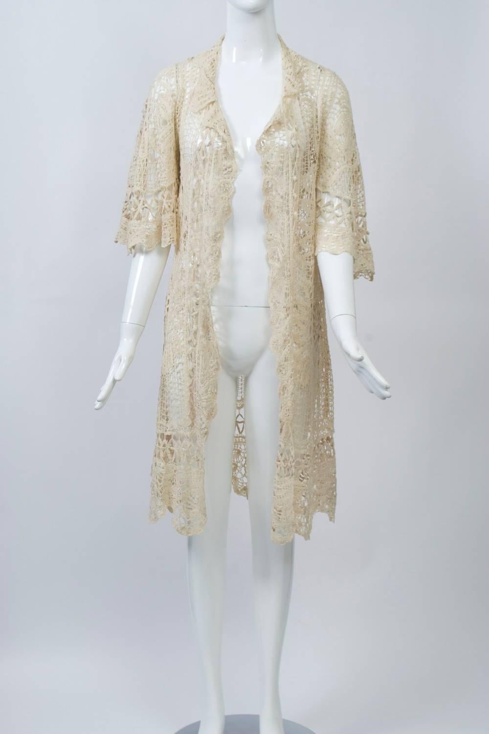 Ivory lace coat with beautiful detailing. Open front, relaxed open collar, and elbow-length wide sleeves. 