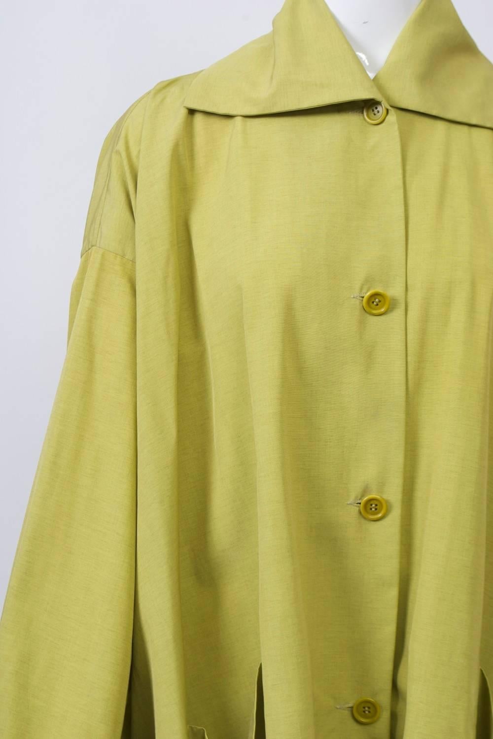 Oversized shirt in a chartreuse silk blend by Romeo Gigli, whose designs from the 1980 are much sought after. With its oversized, swing design, the shirt features a large spread collar, turned-back cuffs on wide sleeves with dropped shoulders, and
