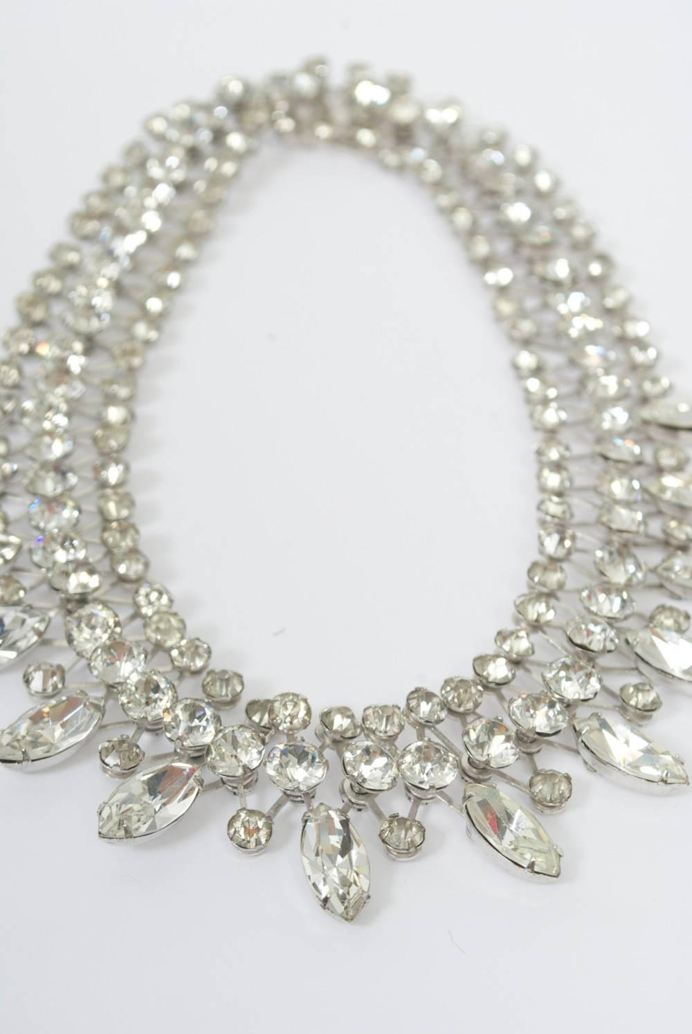 Vintage rhinestone necklace by Eisenberg, known for producing some of the best American costume jewelry with high-quality Svarowski or Czech crystals. This example is constructed of three rows of small faceted crystals in a diamond patterned open