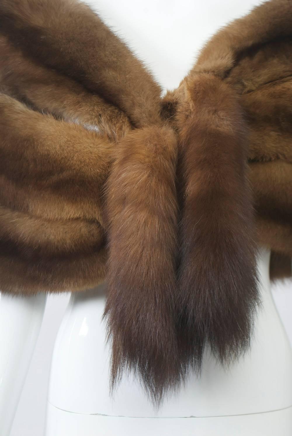 Triple-pelt sable stole, c.1950s, the three skins loosely connected and finished with tails at closure, which features chain and snap as well as fur hook. Continuous sable skins on reverse side. Skins are supple and full.