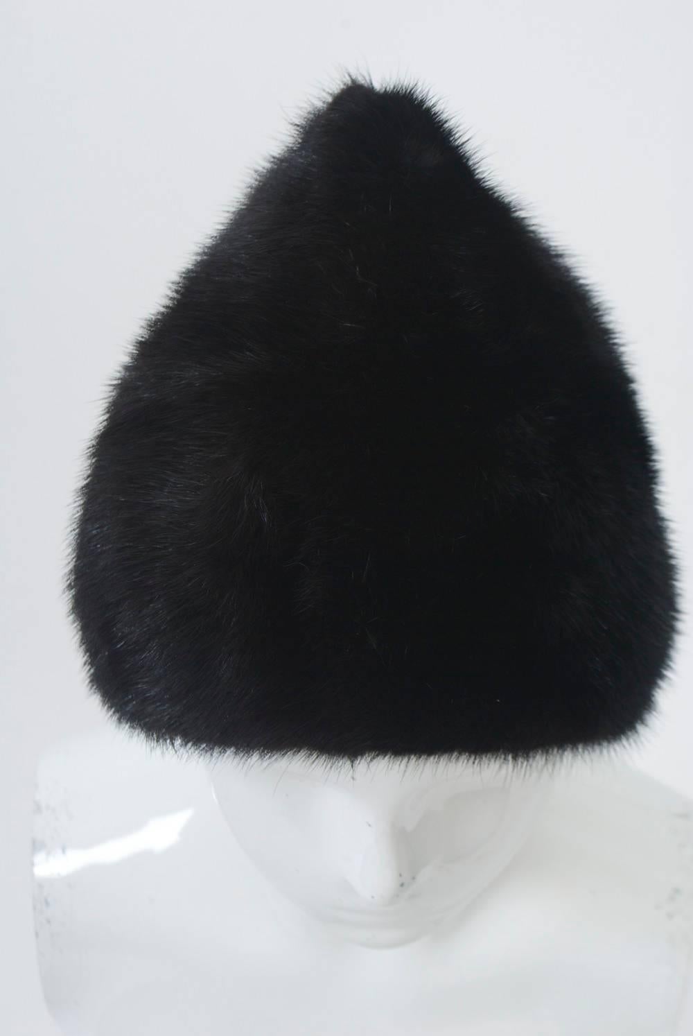 Peaked mink hat in rich, dark mink with deep profile that covers the ears and reaches to the nape of the neck for warmth. Fits S-M head - approximately 22.5