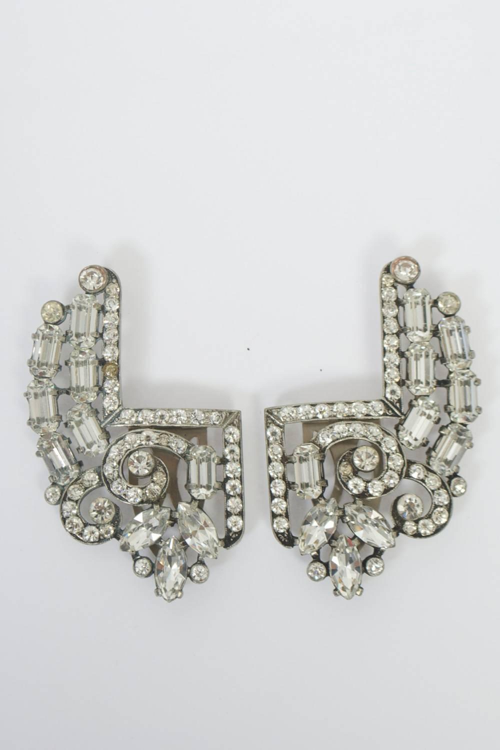 Pair of large rhinestone clips featuring a squared inner edge and crystals of varying sizes and shapes. Great accessory for dress, coat, fur, even hat.