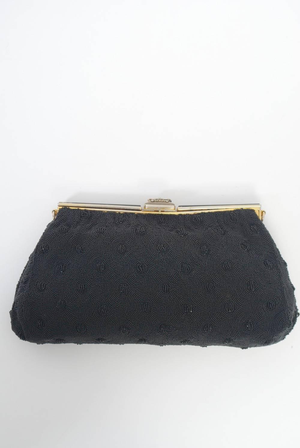 1950s-'60s black microbeaded clutch with fishscale motif of contrasting smooth and faceted beads throughout. The gold metal frame is beaded as well, here with a chain design on top of solid beads, which, both here and in the body lend