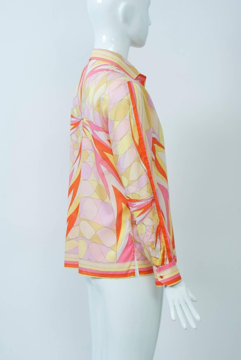 Vintage Pucci cotton voile shirt in orange, pinks, and yellows graphic print bordered in matching stripes. Tiny self buttons down the front and at wrists. Side slits. Signed 