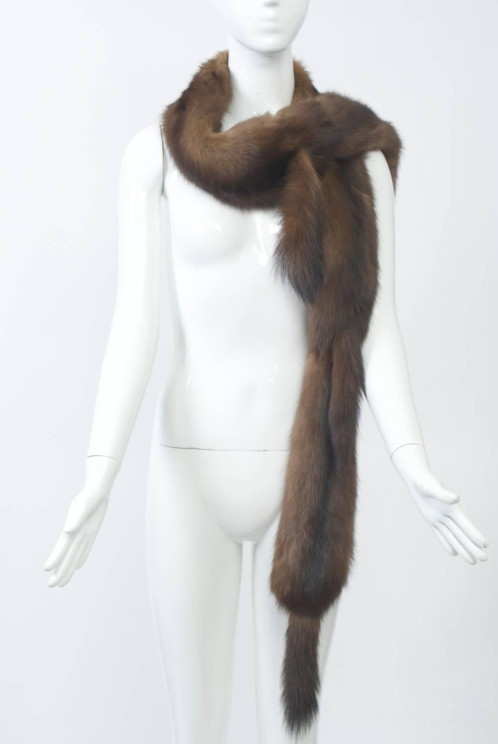 Long sable scarf composed of multiple skins and terminating in tails at the end as well as where the skins meet in front. Sable on reverse. Wear it different ways.