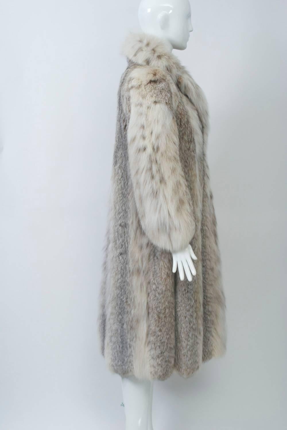 Vintage lynx coat, c.1970s, with lovely markings and supple, luxe skins. Notched collar and slit pockets. Lined in beige silk with interior tie to hold in place. fur hook closure. Size S.