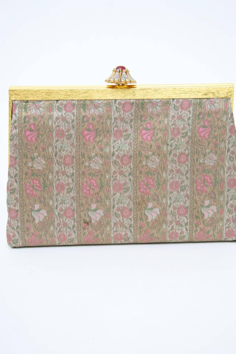 Floral pattern clutch in a subtle palette of pinks and greens by Koret, known as one of the best creators of handbags in mid-century America. This evening clutch has a textured gold frame complemented by a flower-shaped clasp of rhinestones