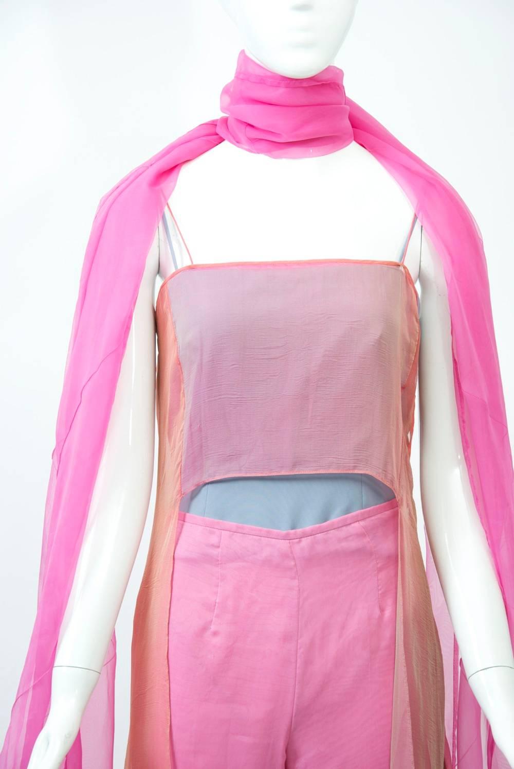 1990s Armani rainbow pants ensemble composed of four pieces - pink pants, a blue bustier/bodysuit, a rainbow asymmetric tunic, and a pink scarf. The pants, with side zipper, are made of two sheer silk layers on top and one heavier fabric underneath.