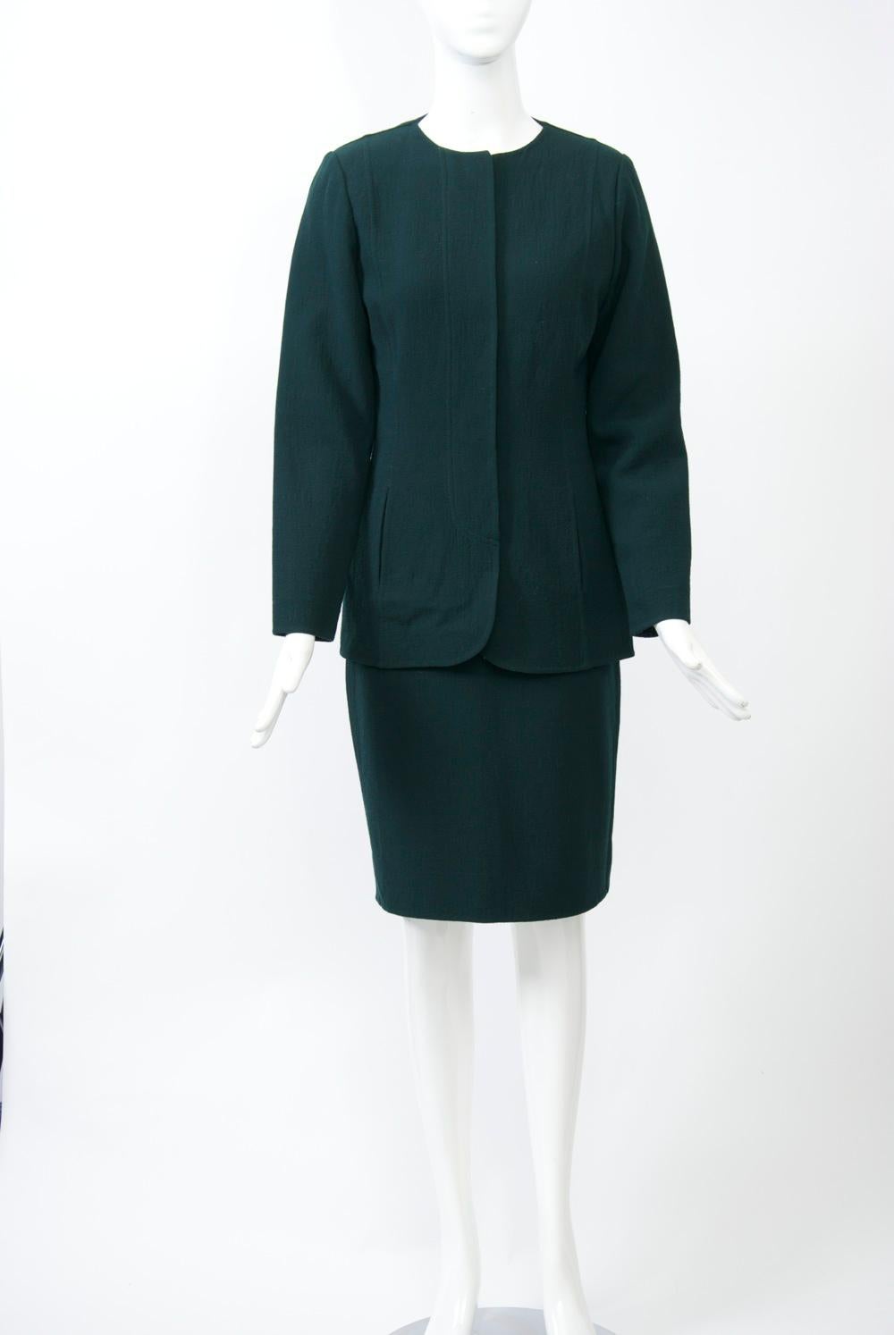 Geoffrey Beene forest green suit, c.1980s, with the seemingly simple, but exquisitely detailed, shaping for which the designer was known. The suit is composed of a wool crepe and features a single-breasted, round-neck jacket with welted seaming and
