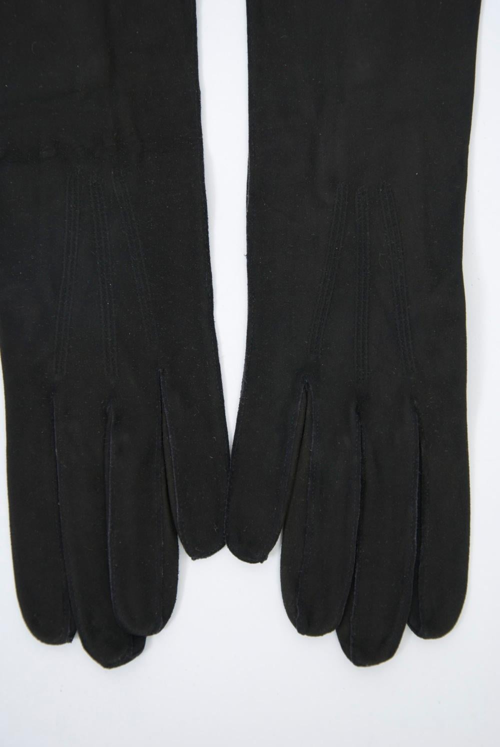 Long black opera gloves in French kid featuring a three-button opening on the wrist side.
