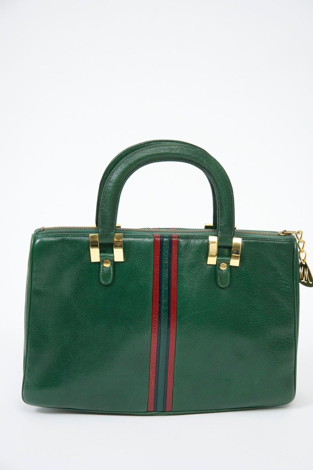 Morris Moskowitz Gucciesque double-handled bag in green leather with red and green vertical stripe down the middle. Zipper top with metal MM pull. White leather interior with zipper compartment.