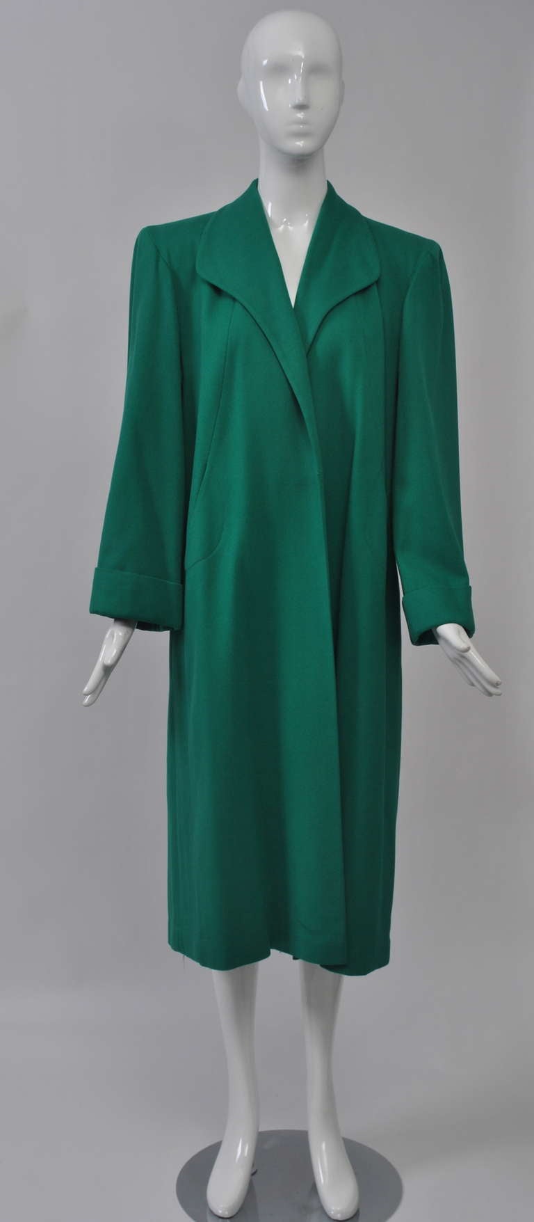 Great color to perk up your Spring or Fall wardrobe, this late'40s-early '50s coat has simple styling with nice details and a loose, open fit. Curved yoke around shoulders and seaming at front with concealed pockets. Gentle spread collar, padded