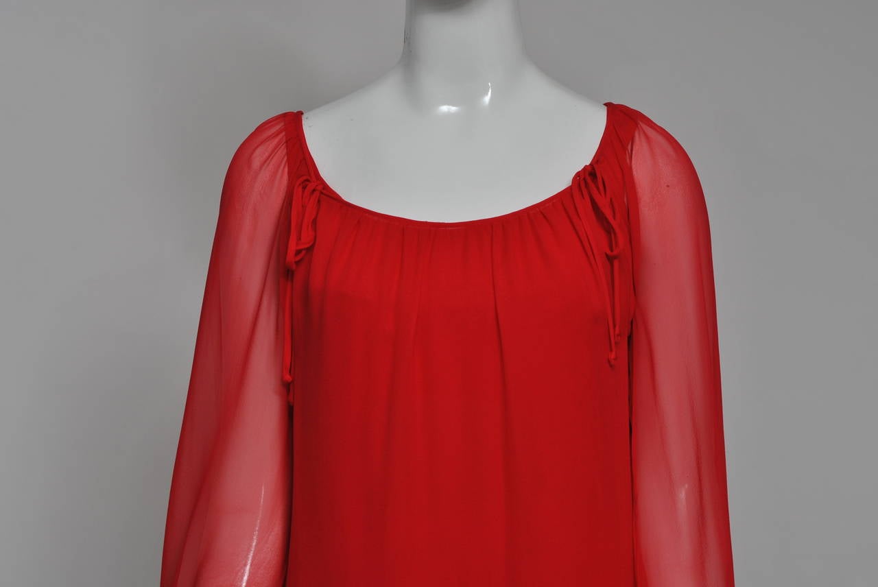 Sibley Coffee was founded in NY in 1966 and was particularly known throughout much of the 1970s for their simple, body skimming designs in silk jersey. This example of their work is composed of two pieces - a sheer red chiffon tunic trimmed in lace