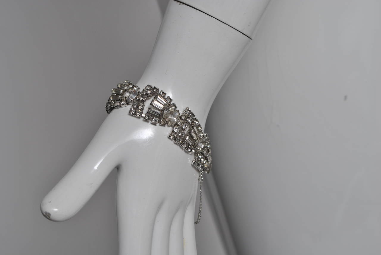 Kramer rhinestone bracelet constructed of triangular-shaped elements of round, marquis and baguette rhinestones. Safety chain.