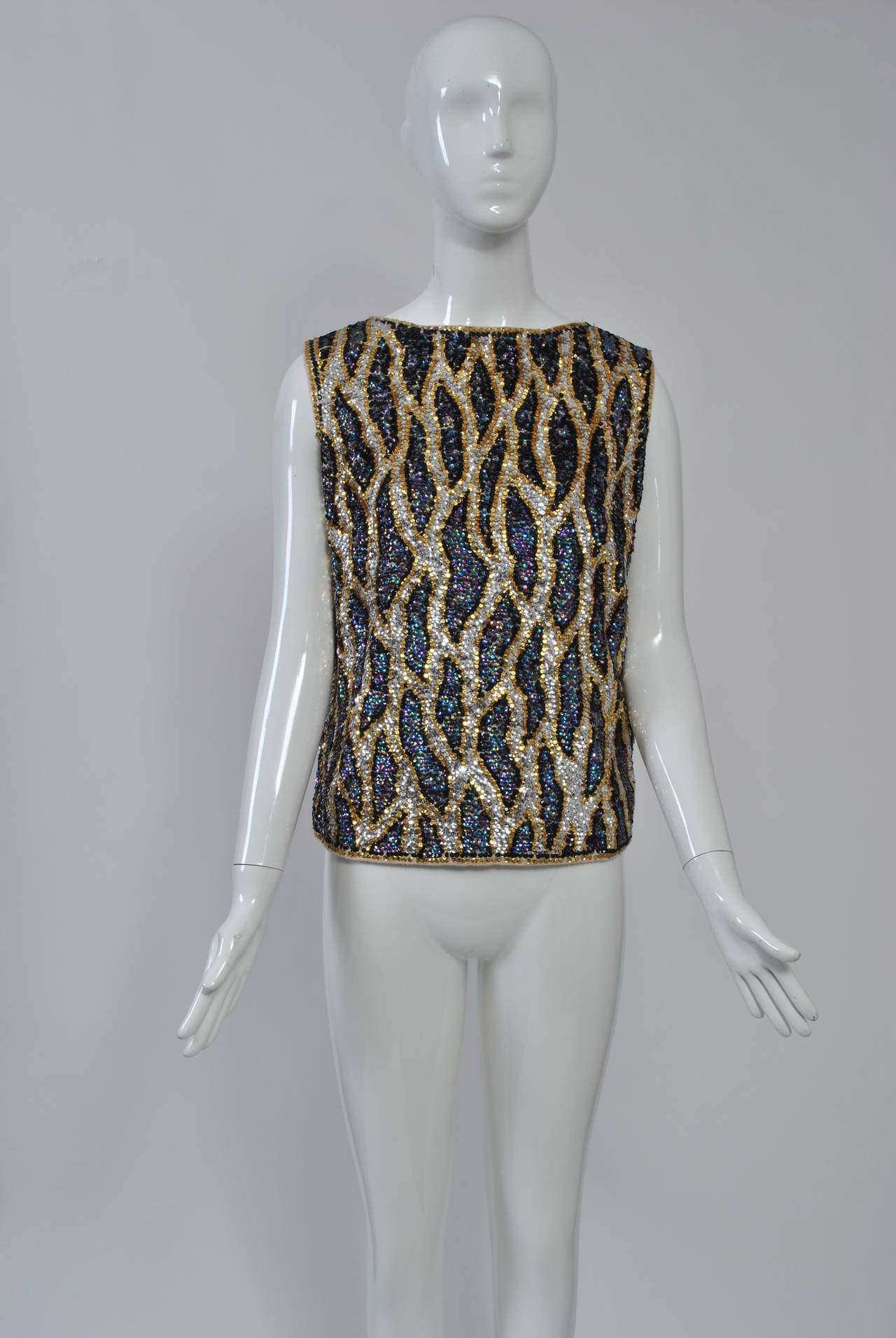 Beaded and sequined knits, mostly made in Hong Kong, were extremely popular during the 1950s and '60s. This example of a shell is among the best and most unusual we have seen, both in its embellished design and its coloring. Back zipper. Lined.