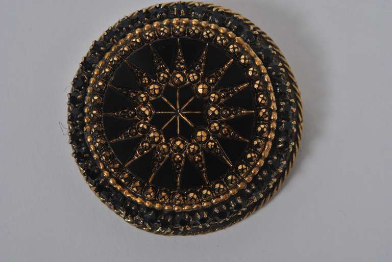 Beautifully worked round brooch by Robert, intricately constructed of faceted black glass in a wreath-like setting. Can be worn as a brooch or pendant.