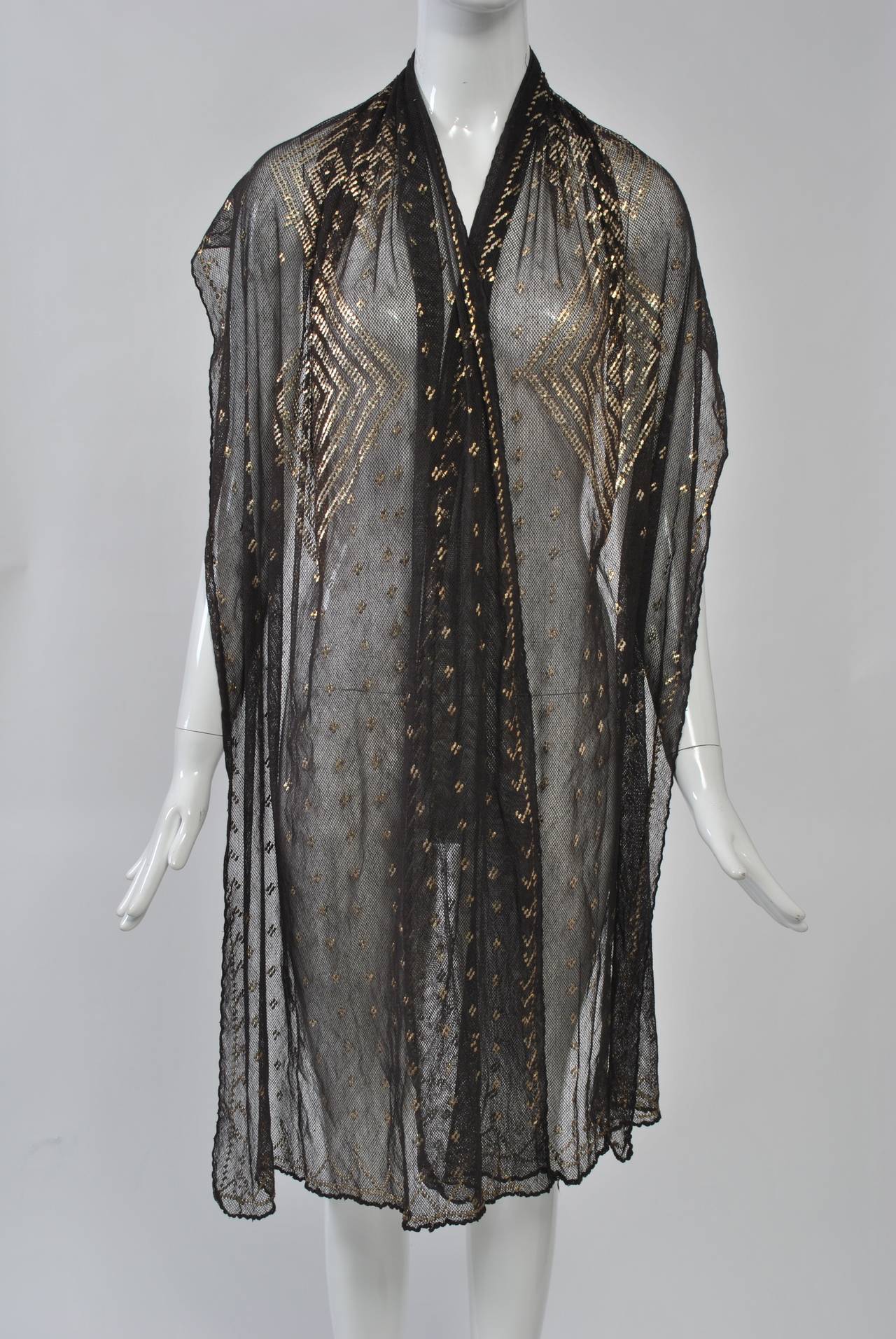 Black assuit shawl with silver metal embroidery in a geometric design. These were made in Egypt and especially popular during the 1920s. Very good condition.