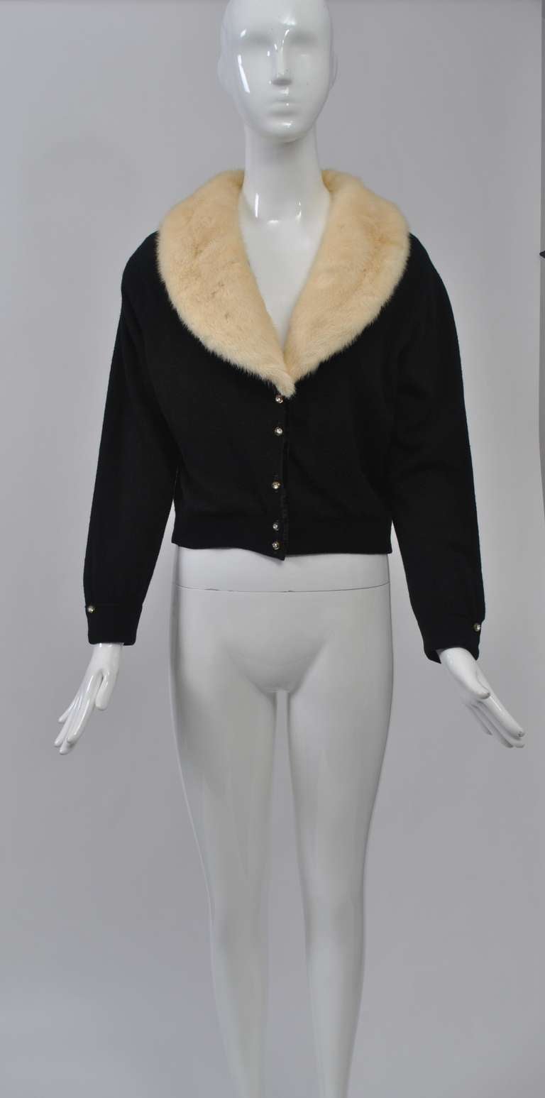 Black cashmere 1960s cardigan with white mink shawl collar and rhinestone buttons down front and at wrists. Lined. Medium size.